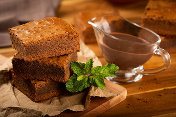Chocolate brownies with chocolate sauce and mint leaves
