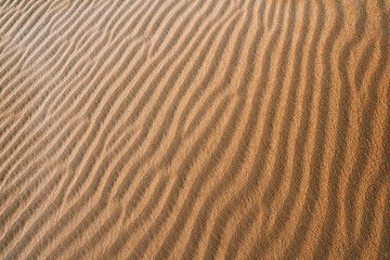 sand texture on a desert dune with patterns in the form of waves created by the wind