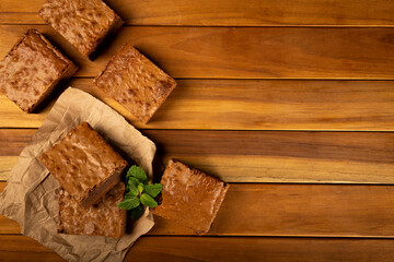 Chocolate brownies stacked with mint leaves.