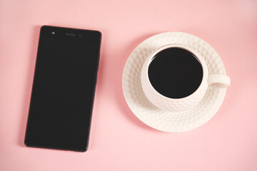 Obraz na płótnie Canvas cup of coffee phone on the table background