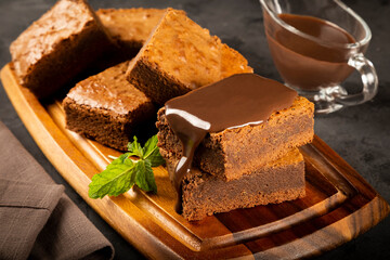 Chocolate brownies with chocolate sauce and mint leaves