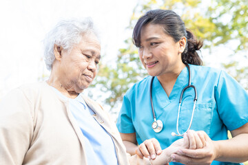 Doctor help and care Asian senior or elderly old lady woman walking at park in happy fresh holiday.