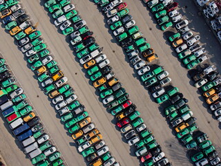 Top view of many cars used for crash testing parked in a row