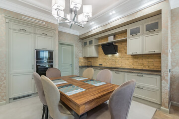 The light and spacious kitchen with built-in appliances. The square dining table with soft chairs...