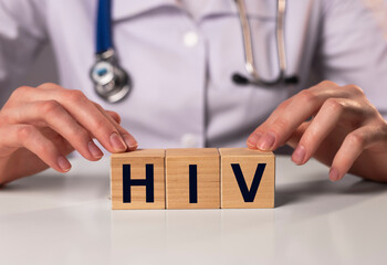 HIV acronym inscription on dices in doctor hands