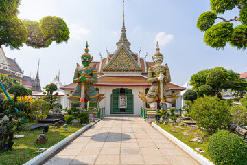 Fototapeta premium Wat Arun Ratchawararam of giants front of the church and nobody in front Entrance door buddhist temple of tourists and landmark popular tourist attractions and cultural attractions in BANGKOK THAILAND