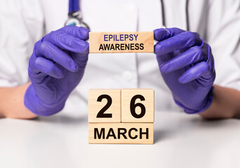 26 March, date on wooden calendar. World epilepsy purple day