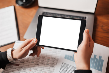 Male hands holding tablet with blank background at workplace. Businessman working at desk with documents