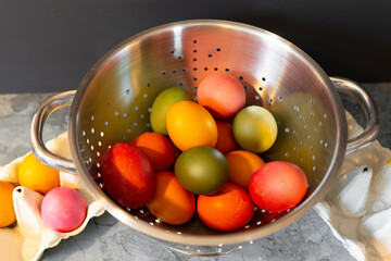 colorful easter eggs in a strainer