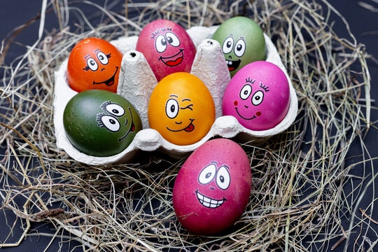 funny easter eggs with face in a egg box