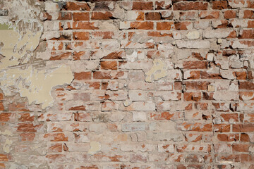 Damaged stone wall with different structure and color, empty facade with grey cement, space for text on the background