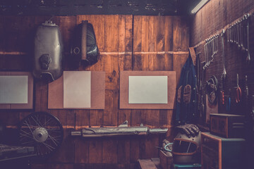 Workshop scene. Old tools hanging on wall in workshop, Tool shelf against a table and wall, vintage garage style, with blank paper