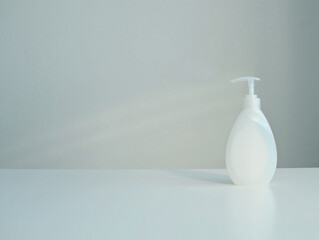 Plastic cosmetic packaging bottle mock up with pump dispenser on white background. Copy space.