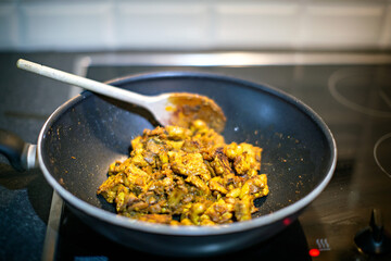 Vegan curry with plant based alternative for chicken meat being cooked in a wok.