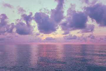 Early morning on the beach. Pink-purple dawn over the sea. Pastel color