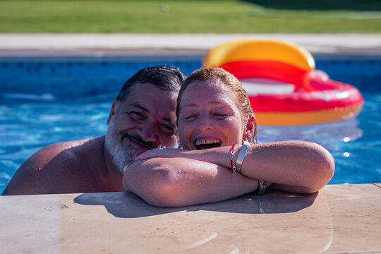 Couple Of Two Adults In Swimming Pool