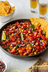 Chili con carne with nachos chips. Mexican food. National cuisine.