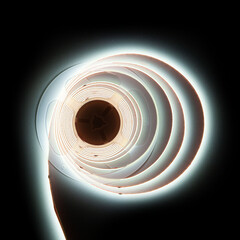 Glowing led strip in roll on black dark background
