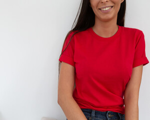 Tshirt mockup, front view of unrecognizable woman wearing red tshirt. Copy space on empty area on her t-shirt for design or inscription. Fashion lifestyle mock up of red tshirt. T-shirt template. - 419689028