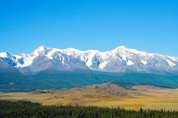 Naklejka premium Beautiful mountain landscape. Snow-capped mountains, steppe and conifers. Russia, Altai mountains, Chuysky ridge