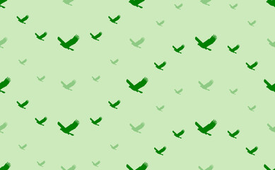 Seamless pattern of large and small green eagle symbols. The elements are arranged in a wavy. Vector illustration on light green background