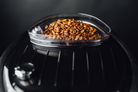 coffee beans in coffeemaker bean container, close-up view