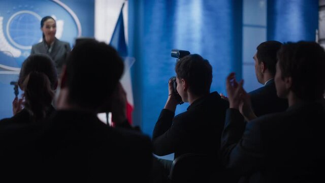 Pool of Photographers and Journalists Working at a Organization Press Conference with Female Representative Delivering a Speech at Press Conference in Government Building. Diplomat at a Summit.