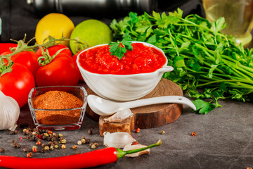 Salsa Sauce. Spicy, colorful Mexican salsa sauce with hot peppers and tomatoes on a dark background.Classic homemade Italian tomato sauce  for pasta  pizza in  on wooden background.