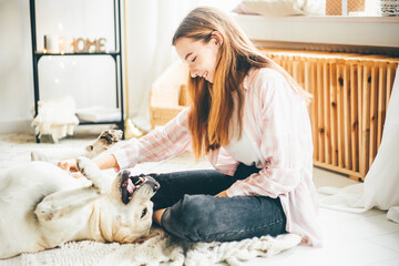 Young girl being in love with her dog. Girl petting a dog. The dog opened his mouth with pleasure.