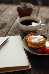 cheese pancakes and coffee on a wooden background