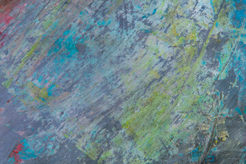 colorful creative motley background: smudged residues of oil paints on a wooden palette, short focus, selective blur