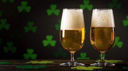 St. Patrick's Day. Glass of Beer or Ale on wooden table and clover leaves bokeh on black background. Feast of Saint Patrick celebration held on 17 March. Macro photography. Close-up with copy space.