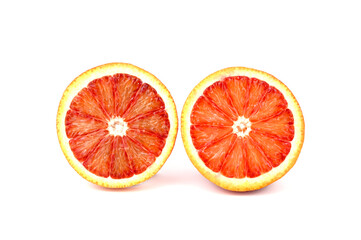 Two halves of a red ripe orange. The cut surface is directed towards the camera.
