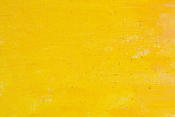 abstract colored creative background: stains of yellow paint-primer on rough linen canvas, temporary object, not an object of art.