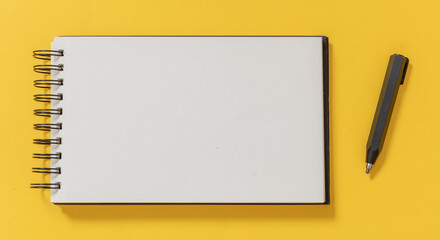 Blank notepad and architect engineer pencil on yellow color background, top view.