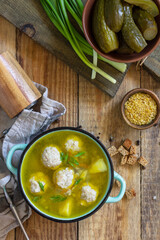 Healthy and diet food. Soup with meatballs and bulgur on a wooden table. Top view flat lay.