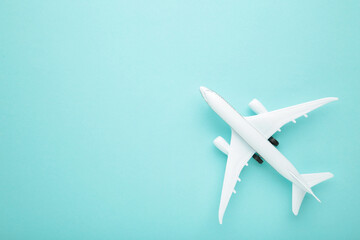 Model airplane on blue pastel color background.