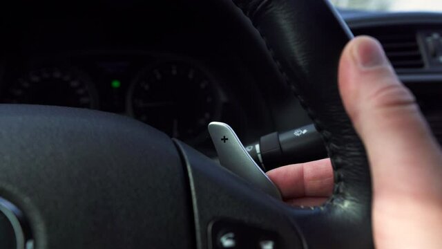 Car interior, shifting gears on the steering wheel