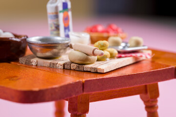 The dollhouse table is packed with food