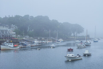 Fototapeta na wymiar USA, Massachusetts, Cape Ann, Gloucester. Annisquam Harbor, boats in fog