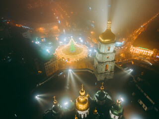 Aerial view from drone at St. Sophia's Cathedral at winter night in fog in Christmas