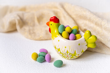Easter concept. Mini eggs in little plate hen on white background. Color eggs pattern, easter background.