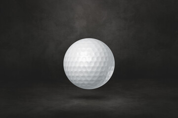 White golf ball on a black studio background
