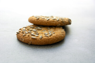 Oatmeal cookies with sunflower seeds on a gray background. Close-up.