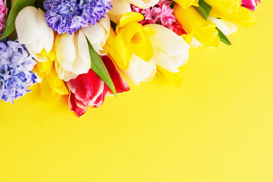 Spring flowers bouquet on a yellow background. Mothers day, Valentines Day, Birthday celebration concept.