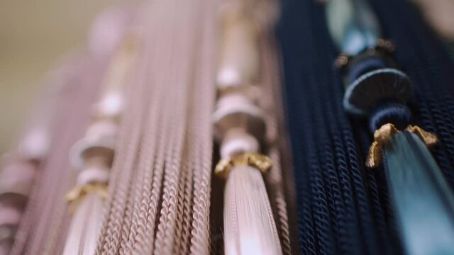 closeup of luxury tieback tassel curtain accessory with fringe at textile store