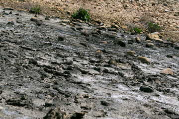 Dry lake environment, rocks, mud, climate change problems, pollution
