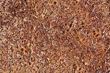 Top crust of homemade fresh bread loaf. Top view close-up texture background.