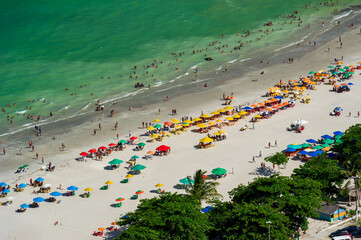 Maria Farinha beach, Olinda, near Recife, Pernambuco State, Brazil on November 15, 2012. Aerial view of the beach with colorful parasols and countless people on the beach.