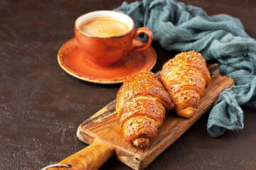 Fresh baked croissant on wooden board